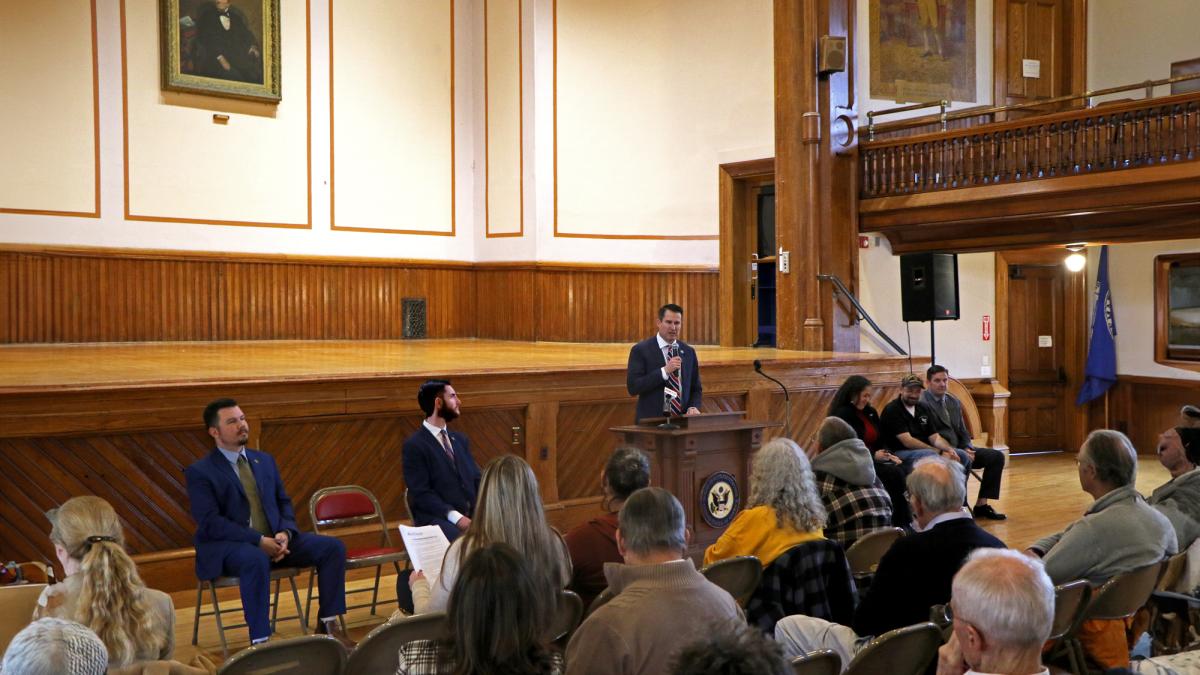 Photo of Rep Moulton speaking in front of a Vets Town Hall audience