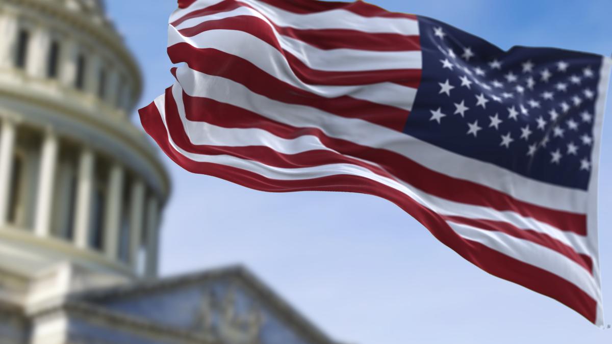 American flag waving over the U.S. Capitol