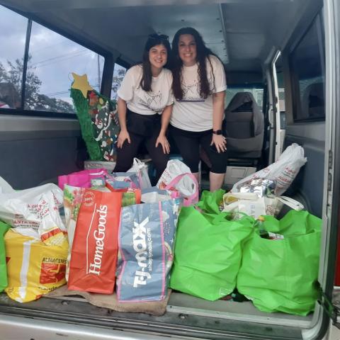 Photo of Nicole's family with bags of goods